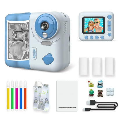 Appareil photo instantané enfant PrintJoy bleu et blanc, vues avant et arrière, avec tirage noir et blanc, rouleaux et accessoires. Bleu