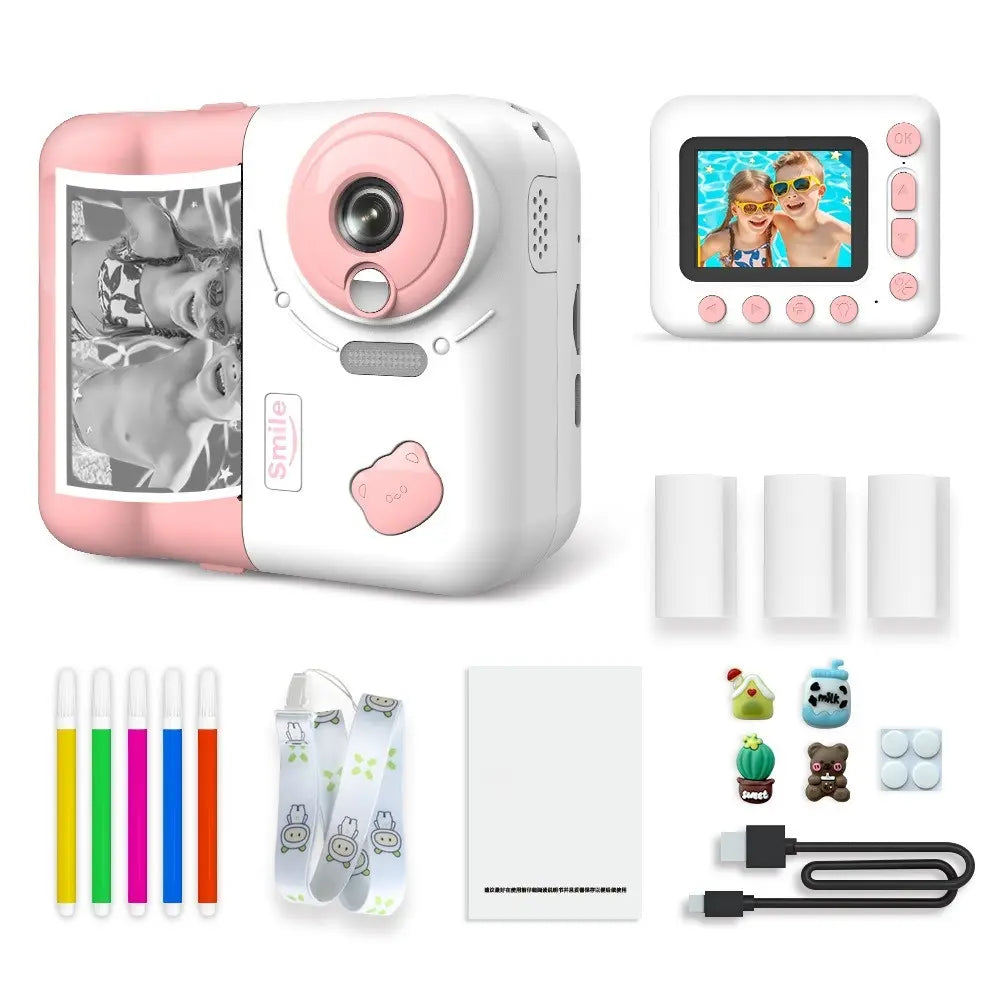 Appareil photo instantané enfant PrintJoy bleu et blanc, vues avant et arrière, avec tirage noir et blanc, rouleaux et accessoires. Rose