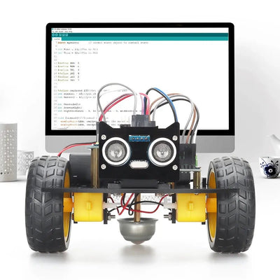 ArduRover™ placé devant un ordinateur affichant un programme dans l’environnement Arduino.