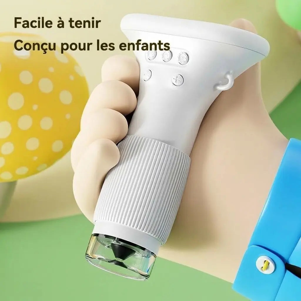 Microscope portable enfant MicroPixel blanc tenu dans une main, avec boutons sous l’écran et bague striée.